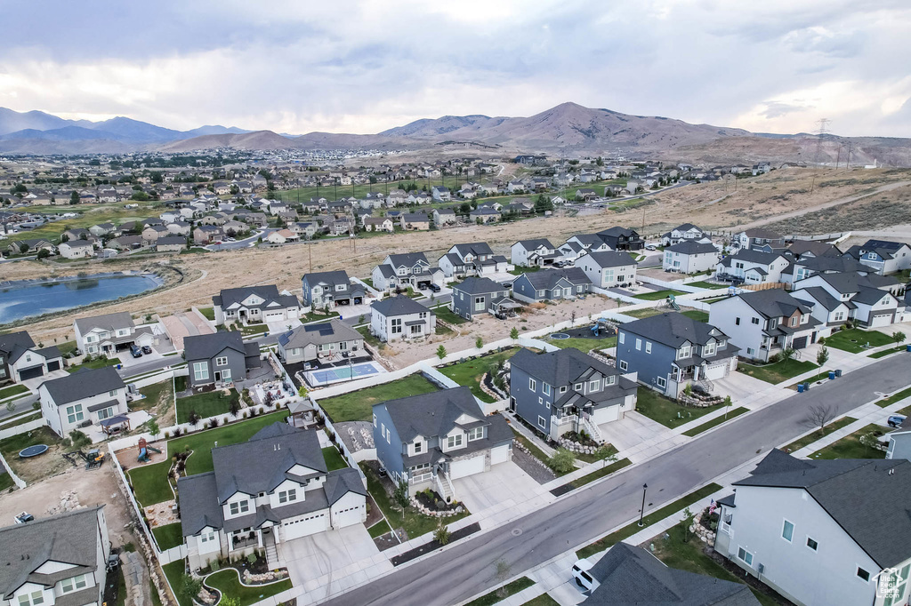Aerial overview of property's location with nearby suburban area and a water and mountain view