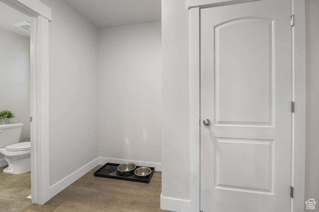Mudroom with wood finished floors and baseboards