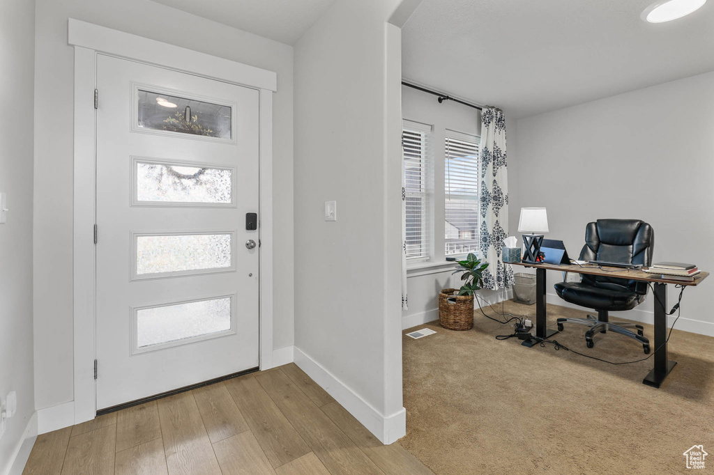 Entryway featuring wood finished floors and arched walkways