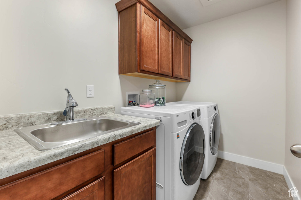 Laundry area featuring washer and clothes dryer and cabinet space