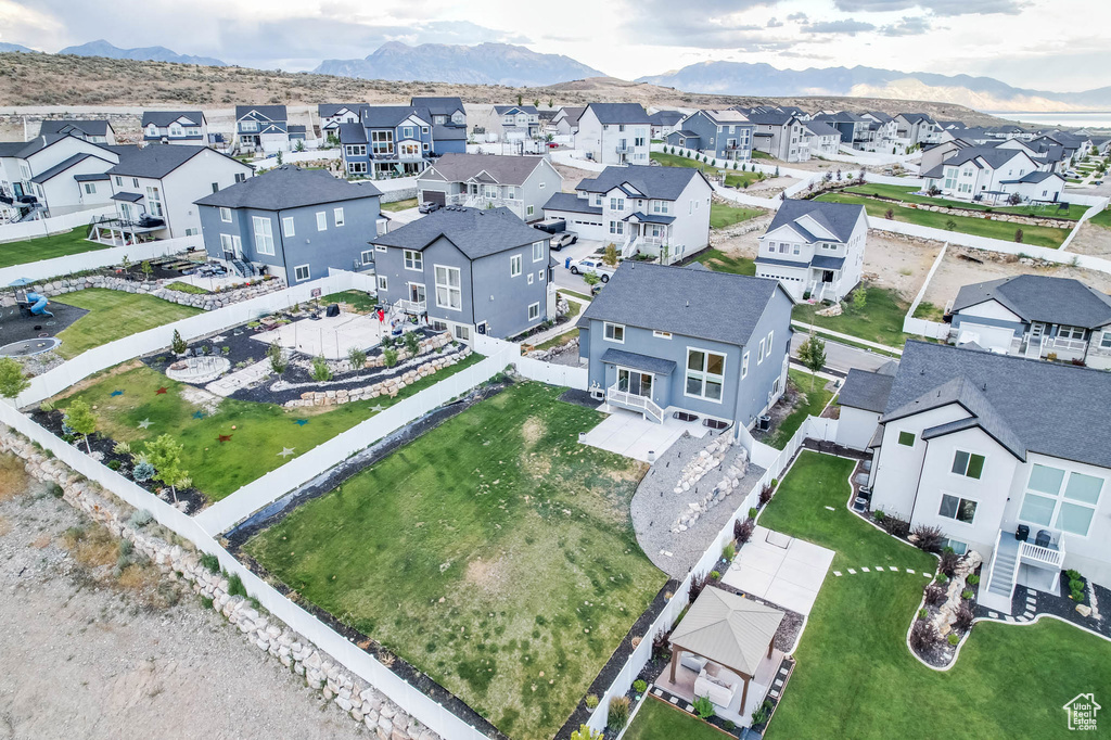 Aerial view of residential area featuring a mountainous background