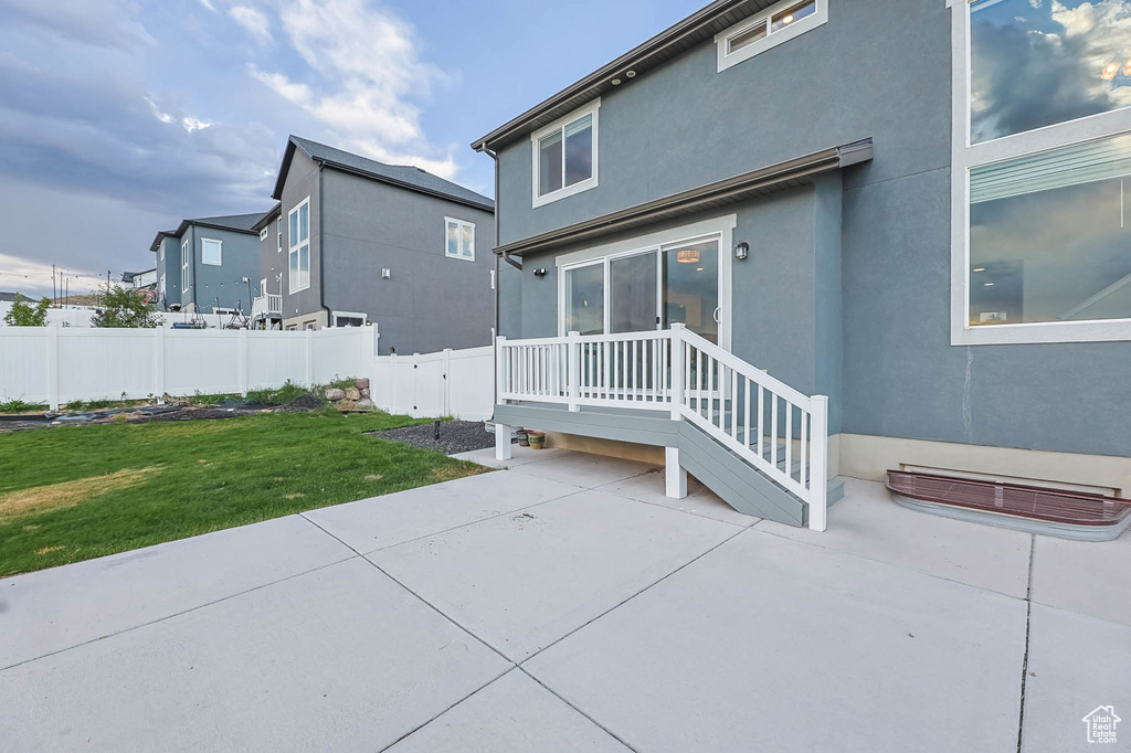 Rear view of house featuring a patio area and stucco siding