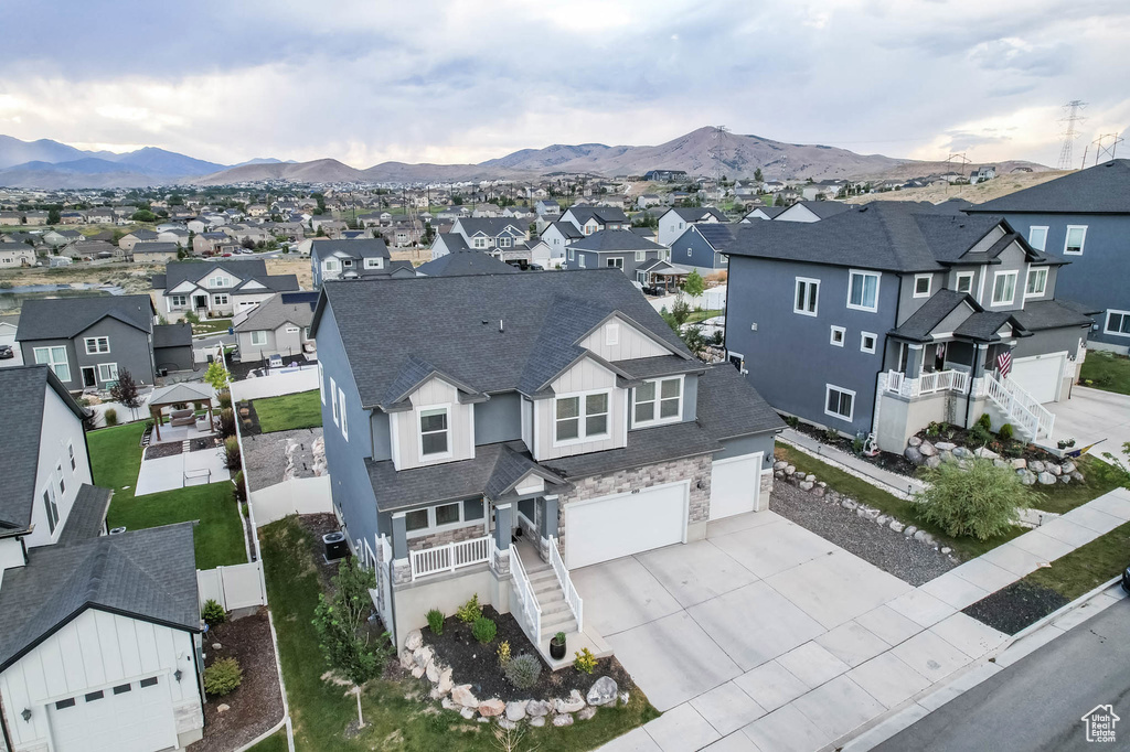 Aerial view of residential area featuring a mountainous background