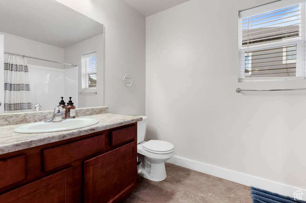 Bathroom with vanity and a shower with shower curtain