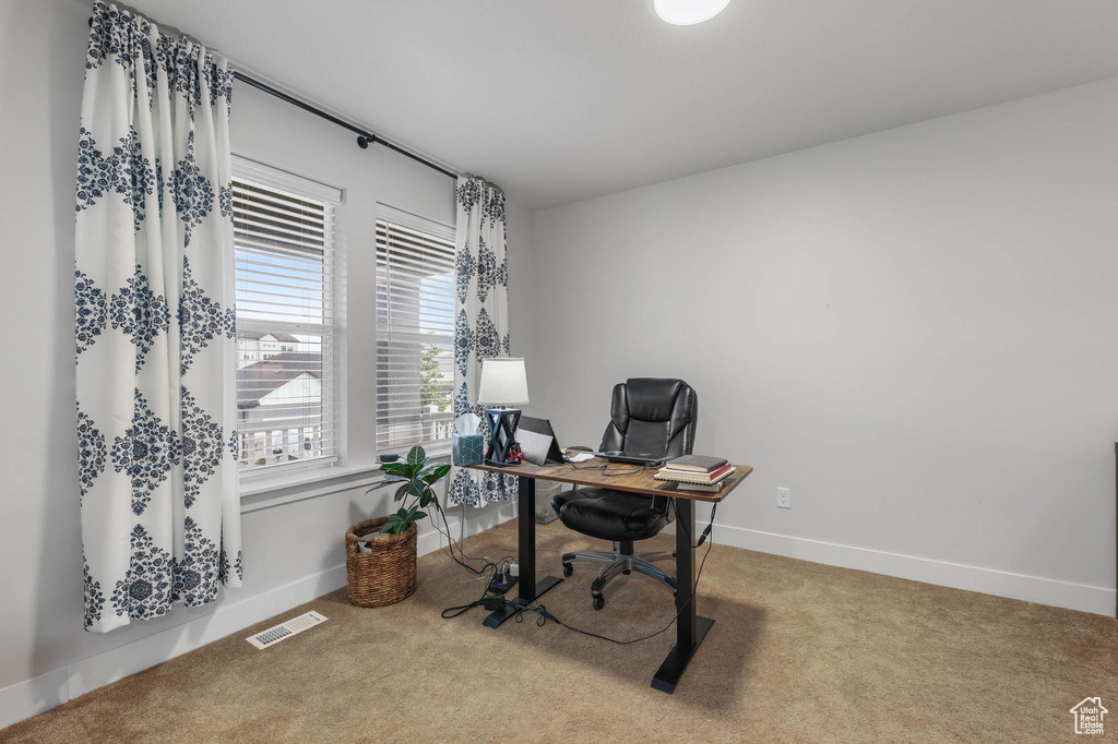 Carpeted office space with baseboards