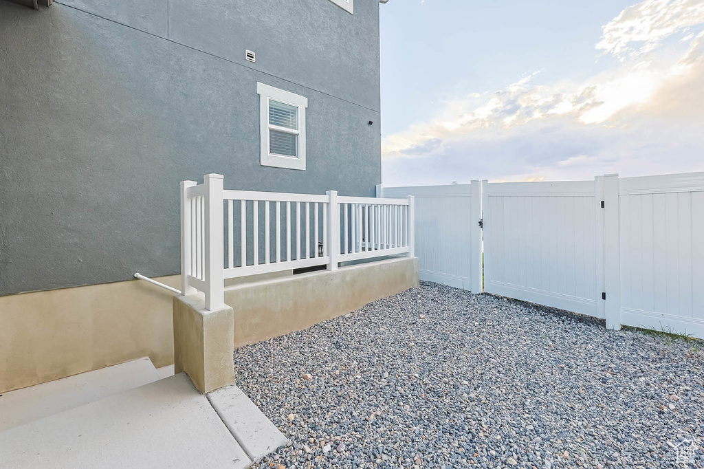 View of property exterior with a gate and stucco siding