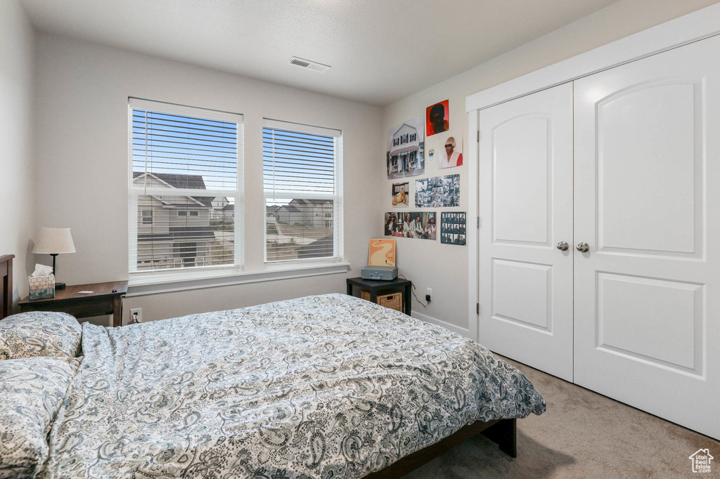 Bedroom featuring carpet floors and a closet