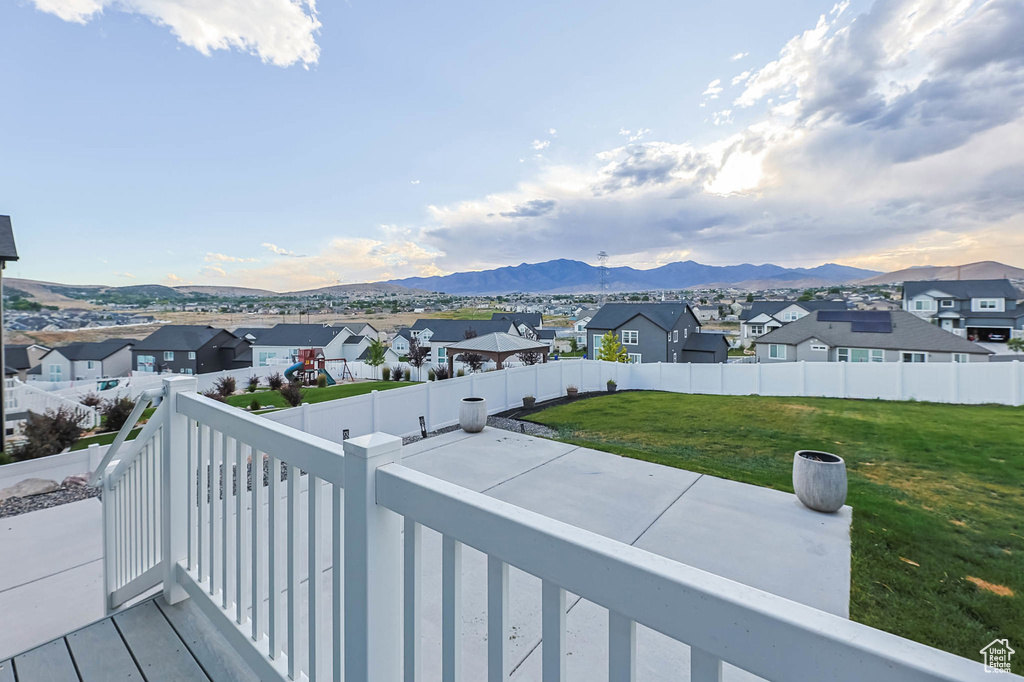 Balcony featuring a residential view and a mountain view