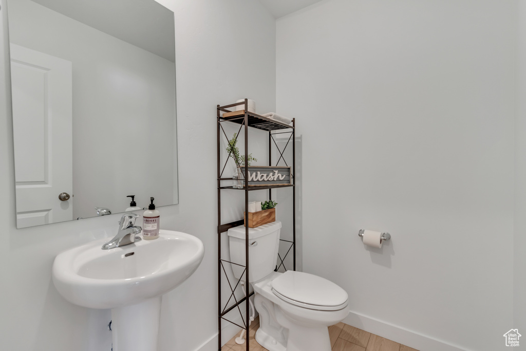 Bathroom featuring toilet and baseboards