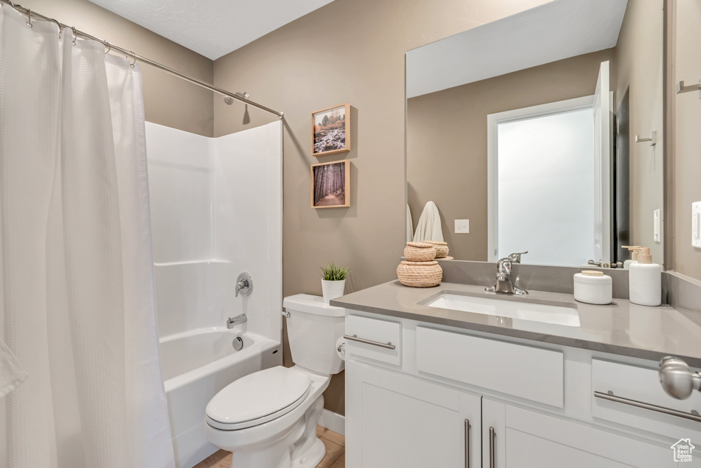 Full bathroom featuring vanity and shower / bath combo with shower curtain