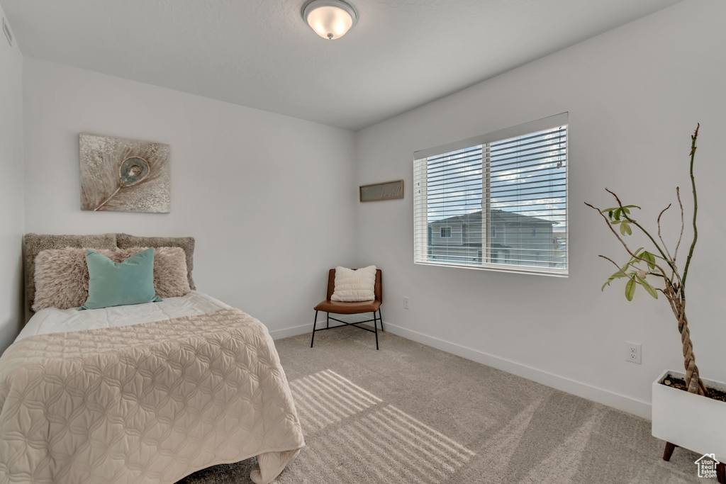 Carpeted bedroom with baseboards