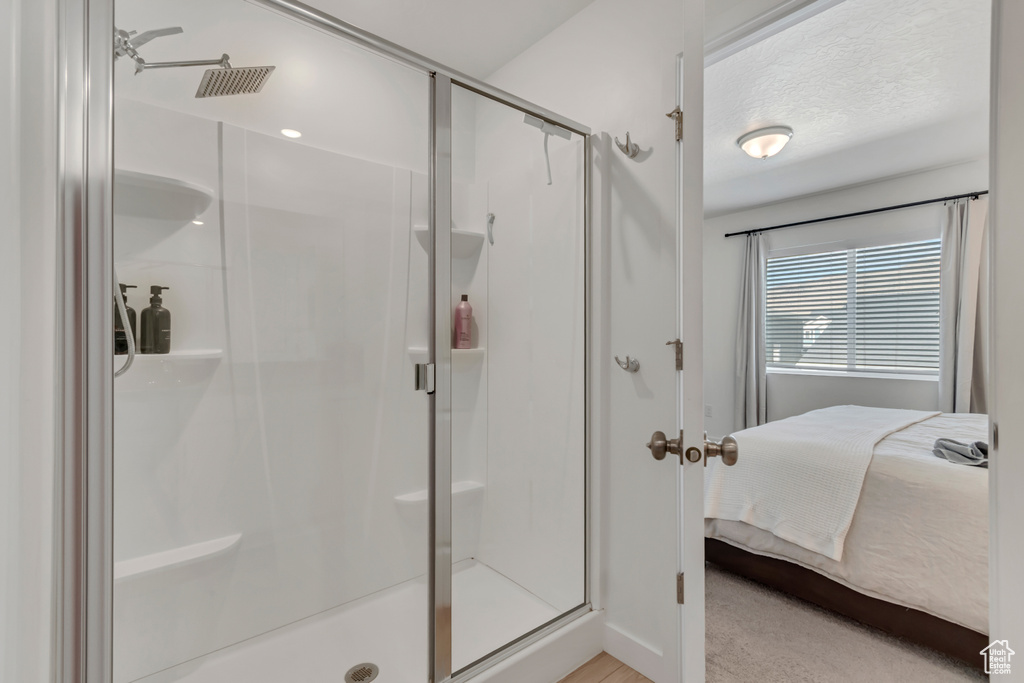 Full bathroom with connected bathroom and a shower stall