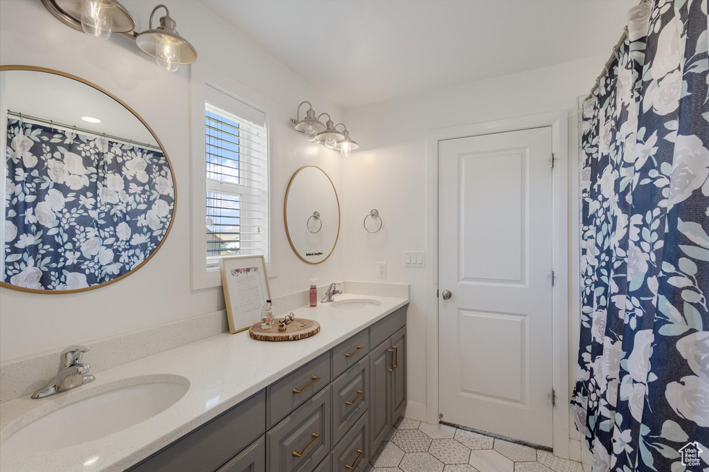 Bathroom with double vanity and tile patterned floors