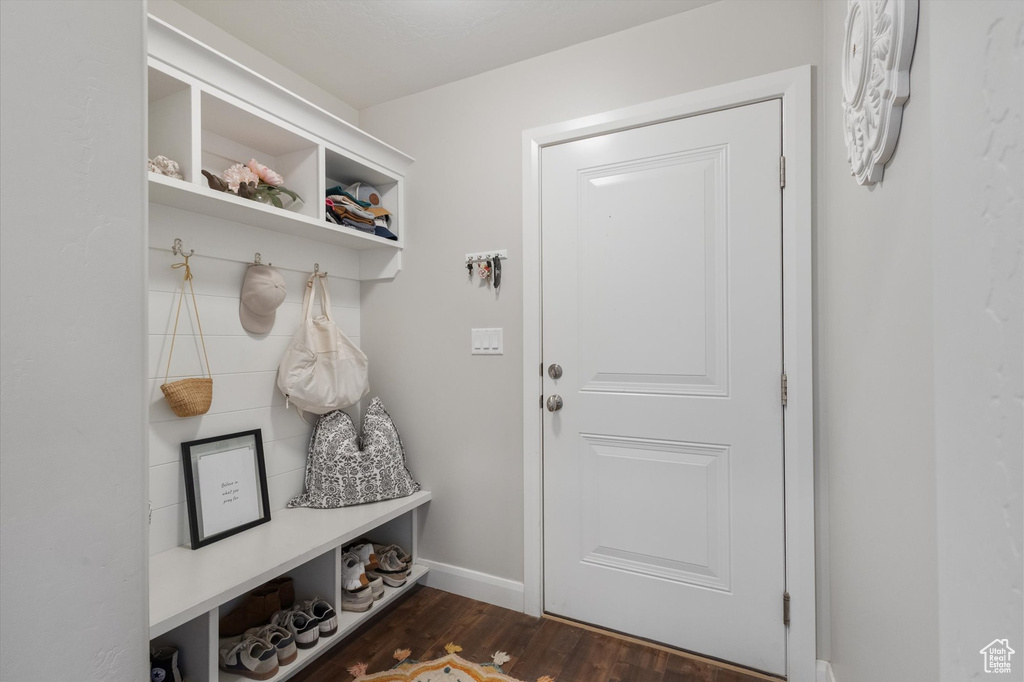 Mudroom featuring dark wood-style flooring and baseboards