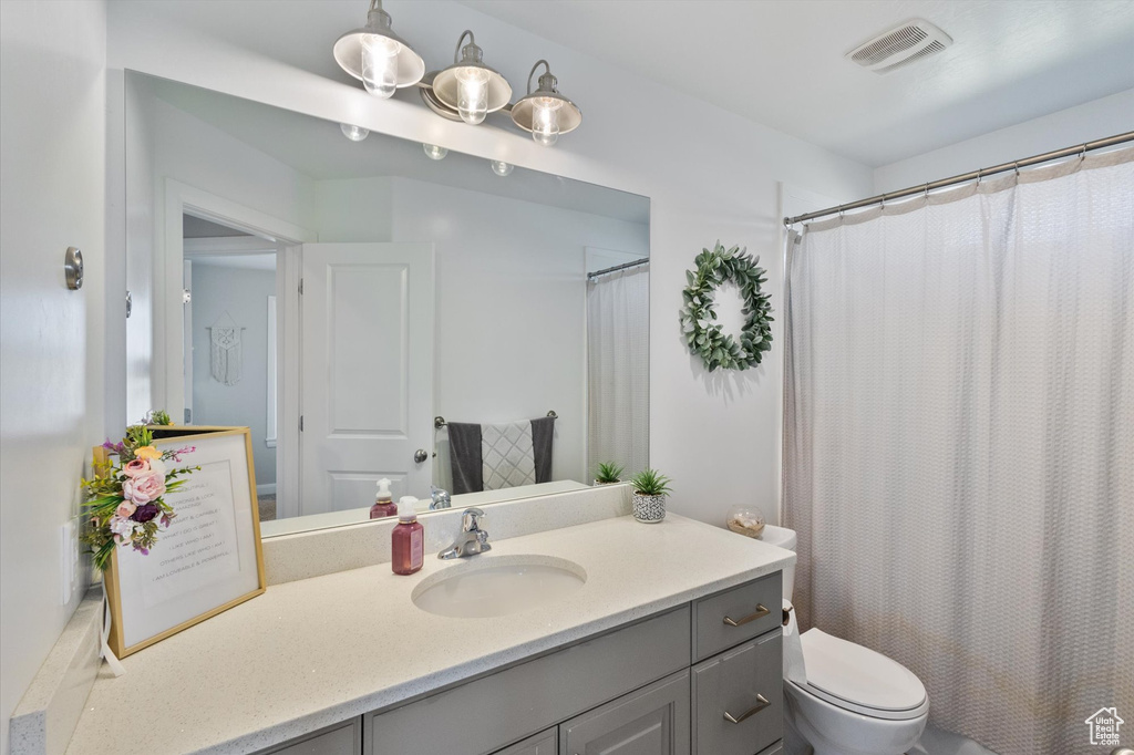 Bathroom featuring vanity and a shower with shower curtain