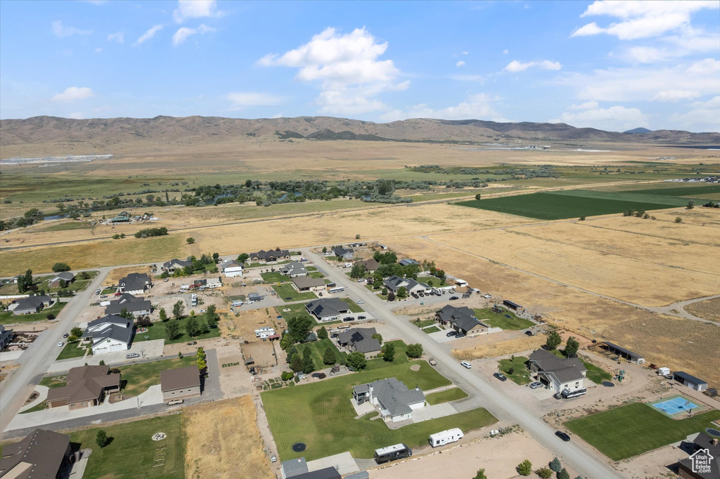 Aerial view of property and surrounding area with a mountainous background