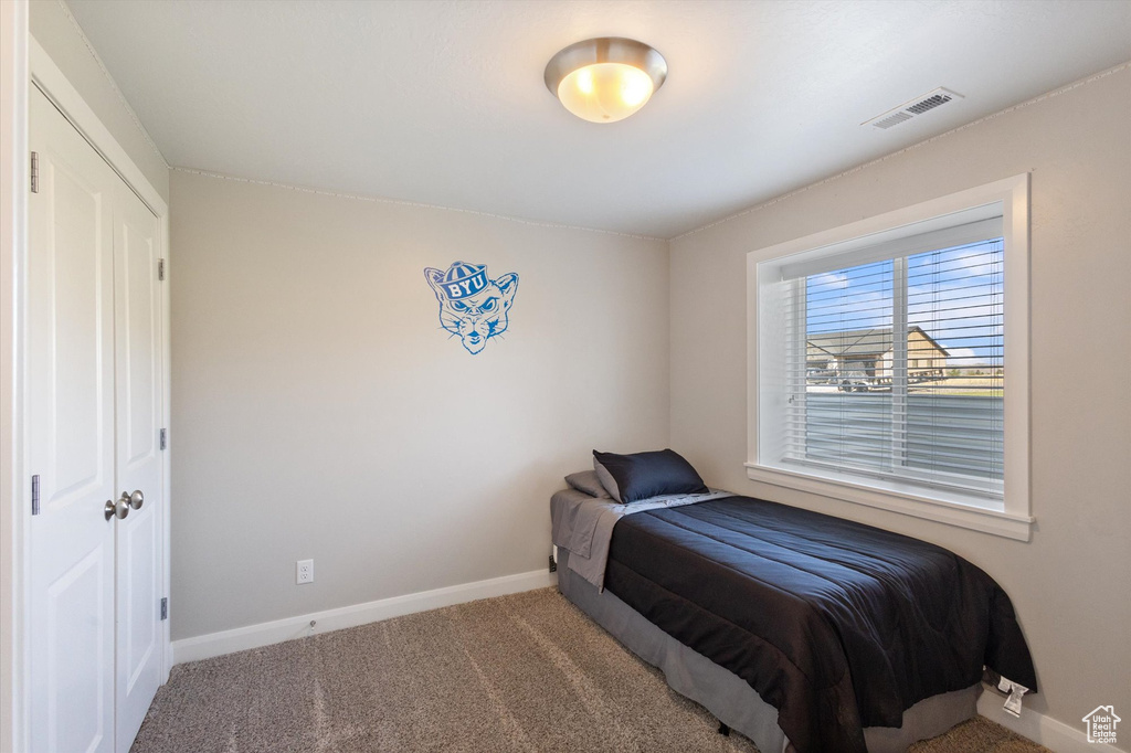 Carpeted bedroom featuring baseboards