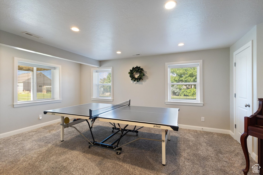 Game room with carpet floors and recessed lighting