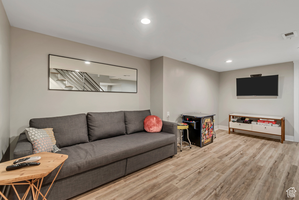 Living room featuring wood finished floors and recessed lighting