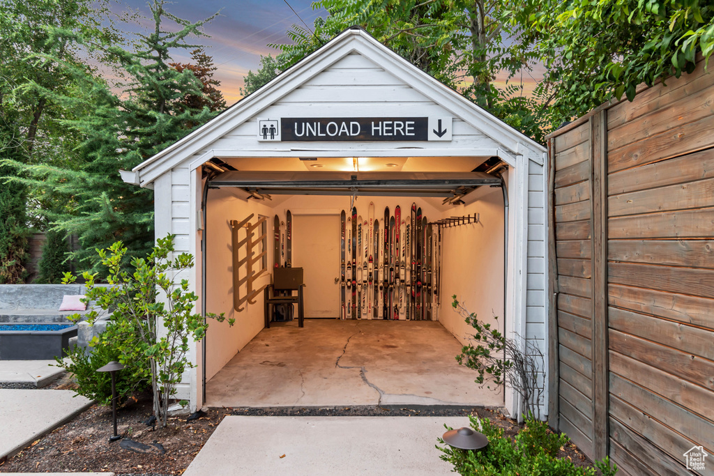 Outdoor structure at dusk featuring a garage