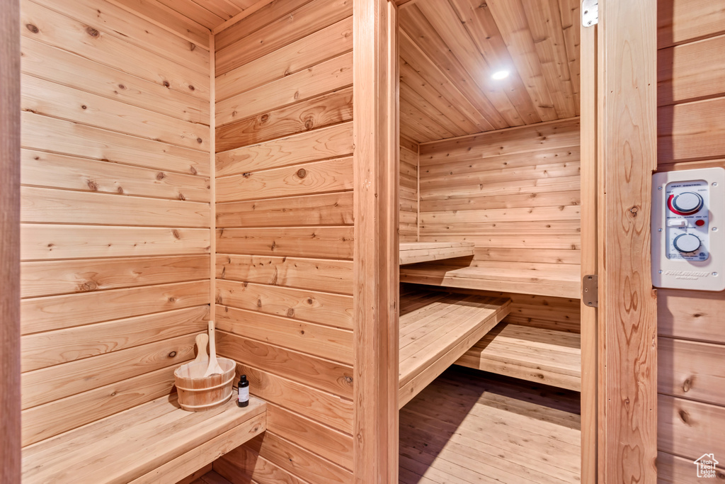 Sauna with wood ceiling, wood finished floors, recessed lighting, and wood walls