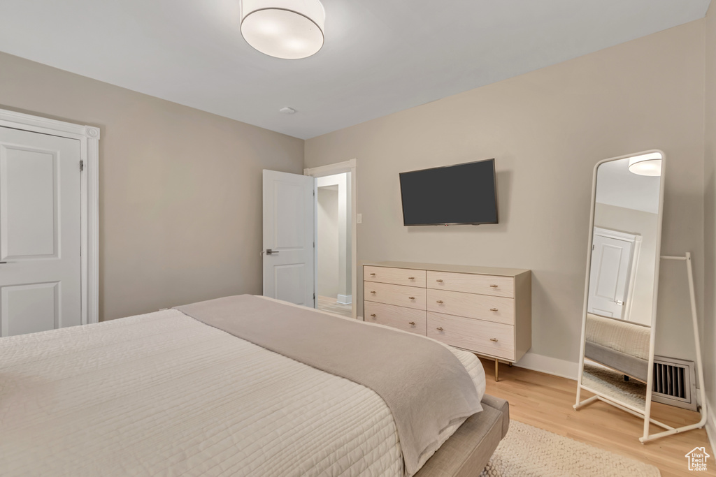 Bedroom with light wood-style floors and baseboards