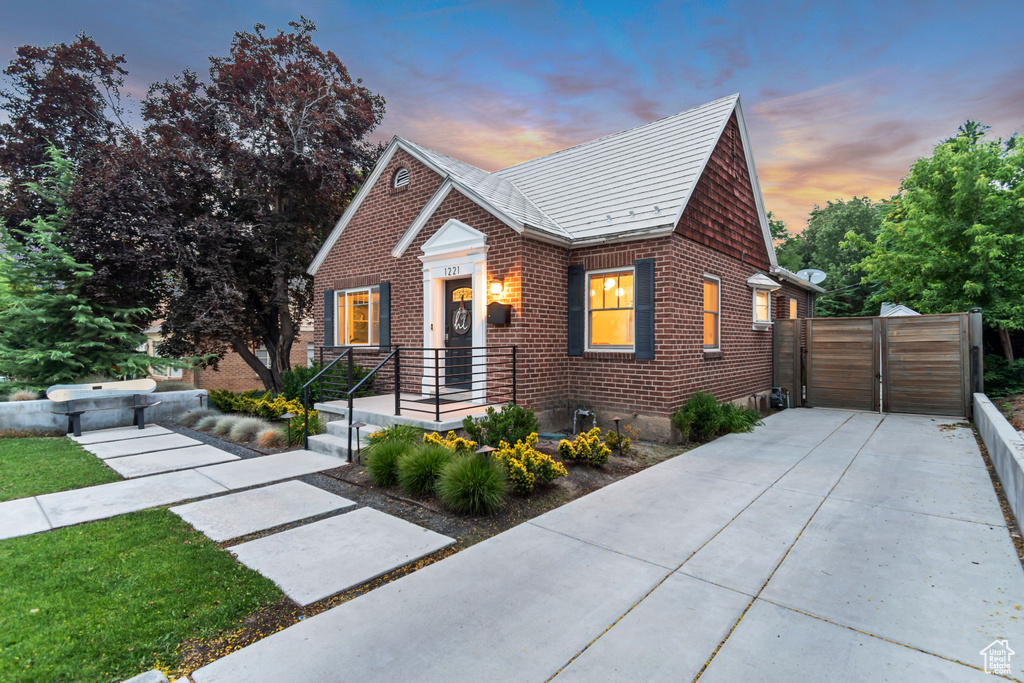 View of front facade featuring brick siding and a gate