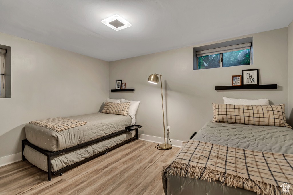 Bedroom with wood finished floors and baseboards