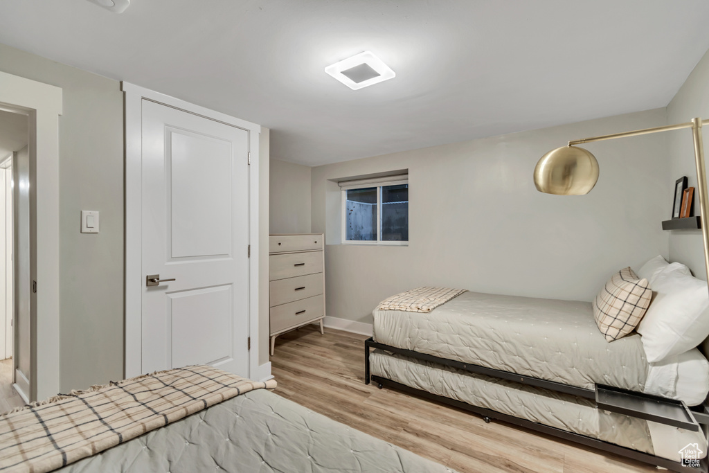 Bedroom with wood finished floors and baseboards