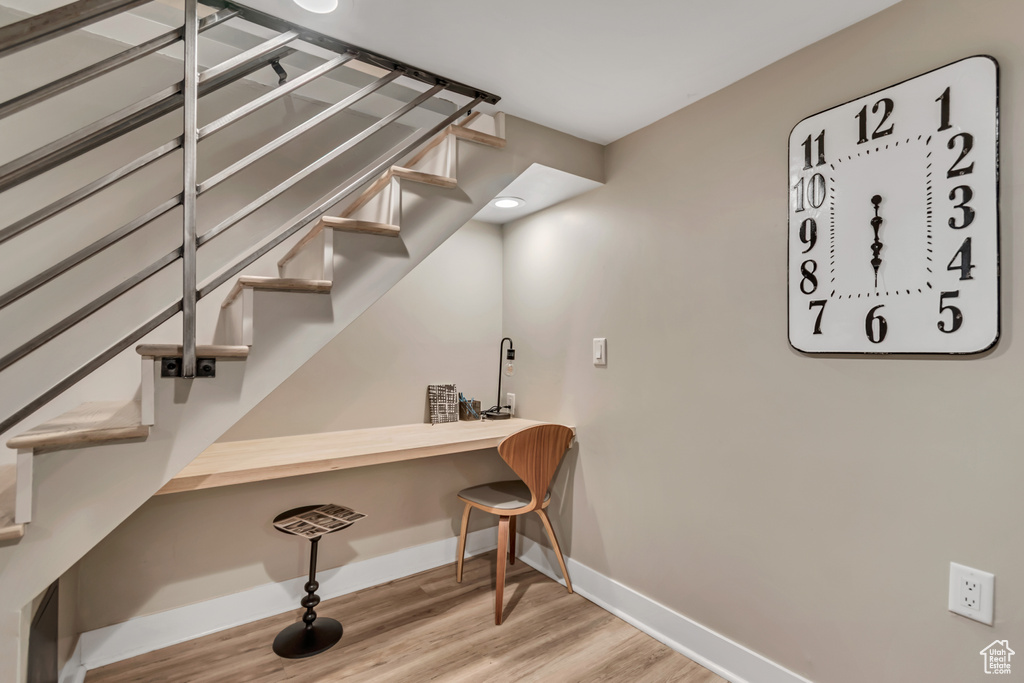 Stairway featuring baseboards and wood finished floors