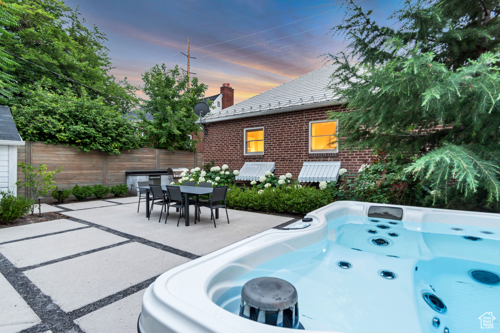 View of patio / terrace featuring a hot tub and outdoor dining area