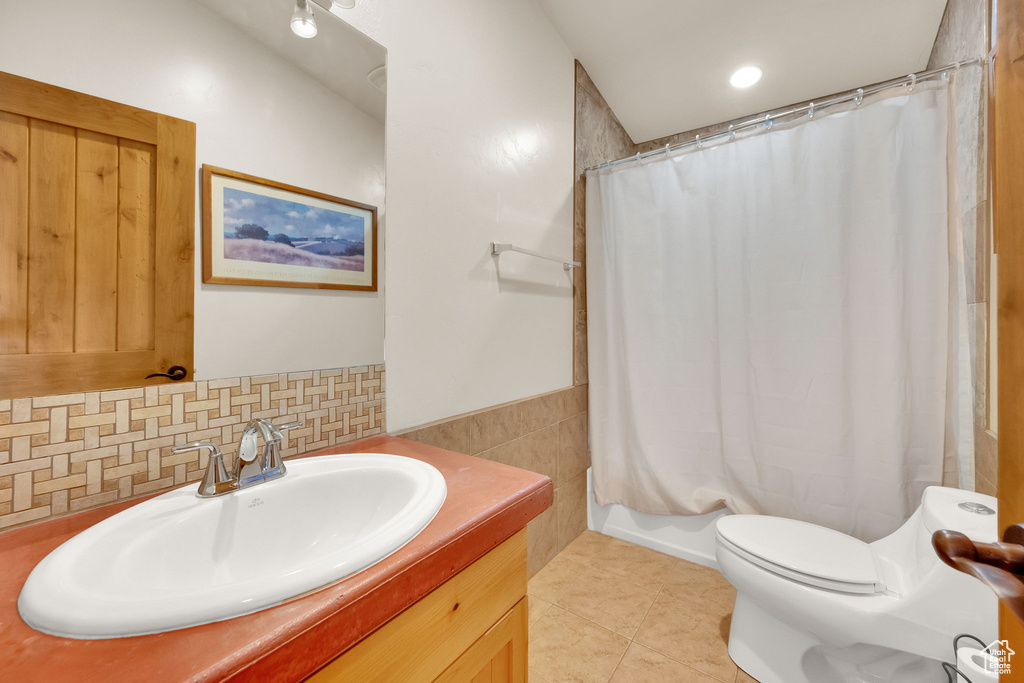 Full bathroom with vanity, tile patterned flooring, and a shower with curtain