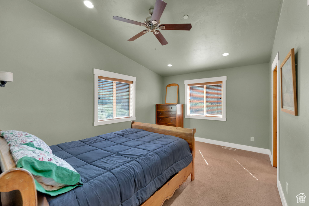 Carpeted bedroom with recessed lighting, multiple windows, vaulted ceiling, and ceiling fan