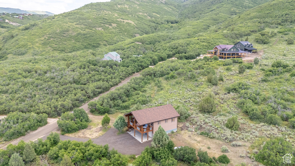 Aerial view of property and surrounding area featuring a forest
