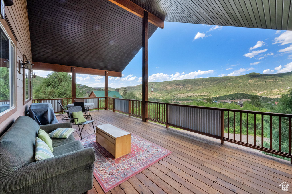 Deck featuring an outdoor living space and a mountain view