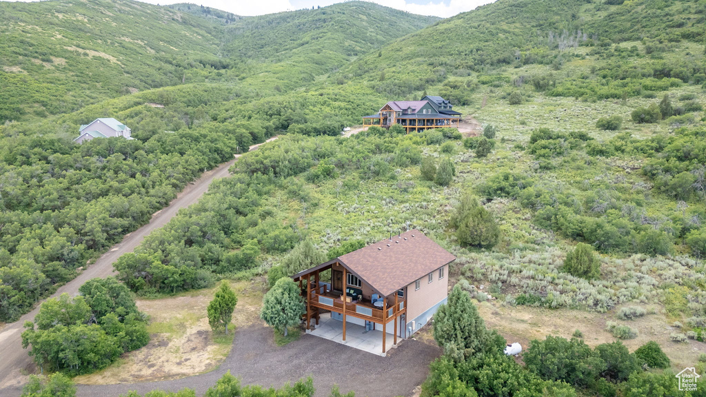 View from above of property featuring a heavily wooded area and mountains