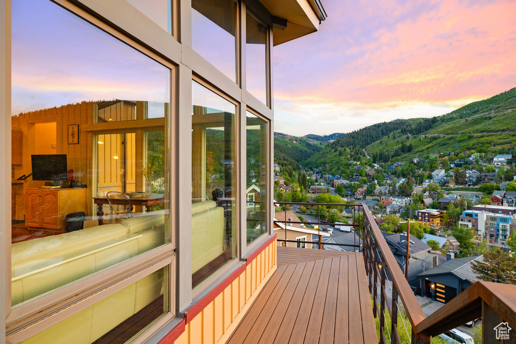Deck at dusk featuring a mountain view