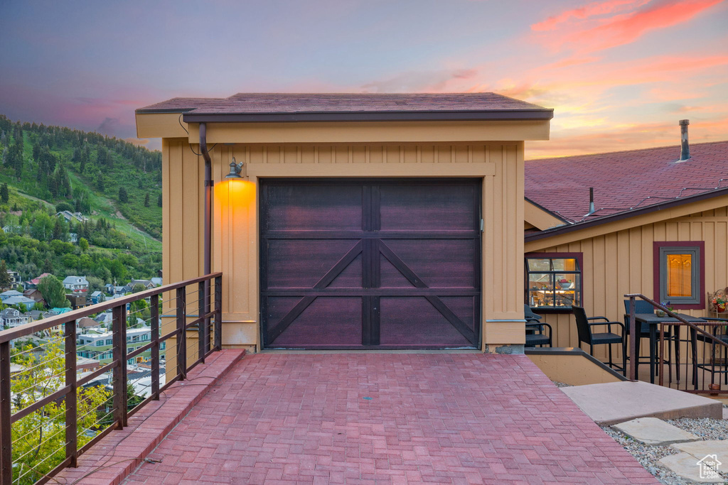 View of garage at dusk