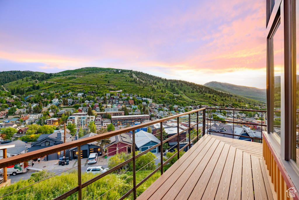 Balcony at dusk featuring a mountain view