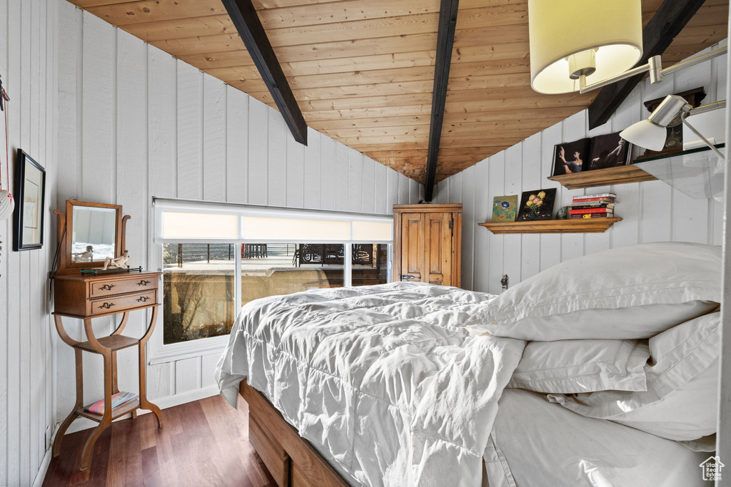 Bedroom featuring wood ceiling, wood finished floors, and wood walls