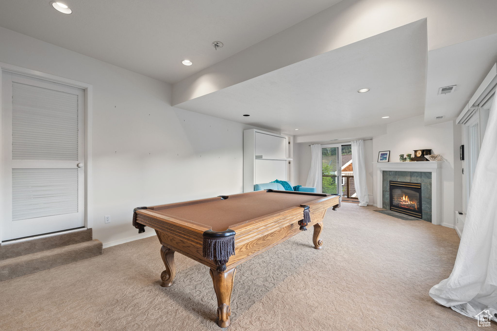 Game room with light colored carpet, recessed lighting, billiards table, and a tiled fireplace