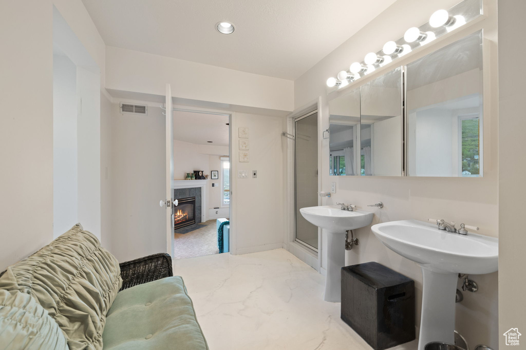 Bathroom with a tiled fireplace and recessed lighting