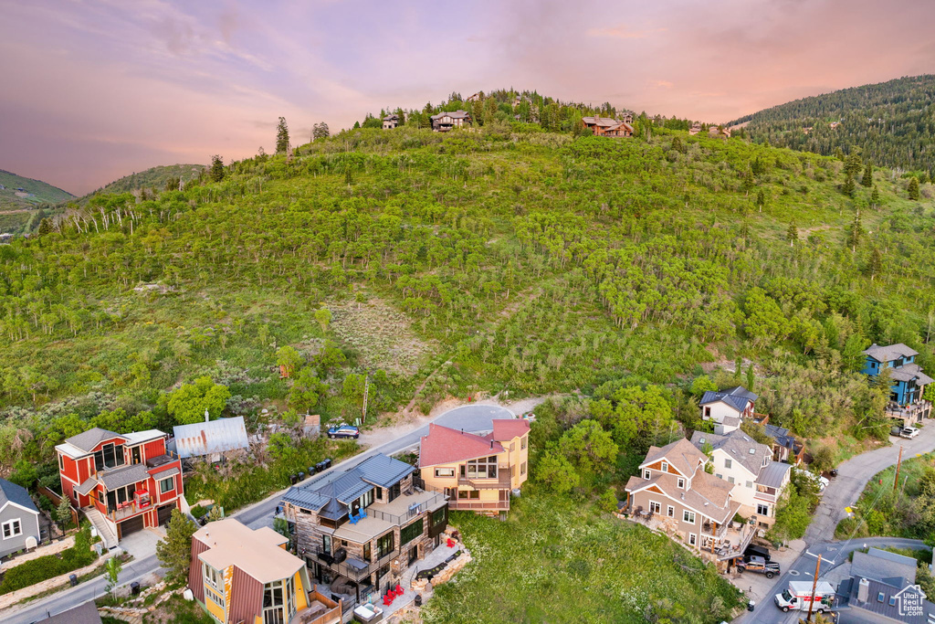 Aerial view at dusk of a wooded view, a residential view, and a mountain view