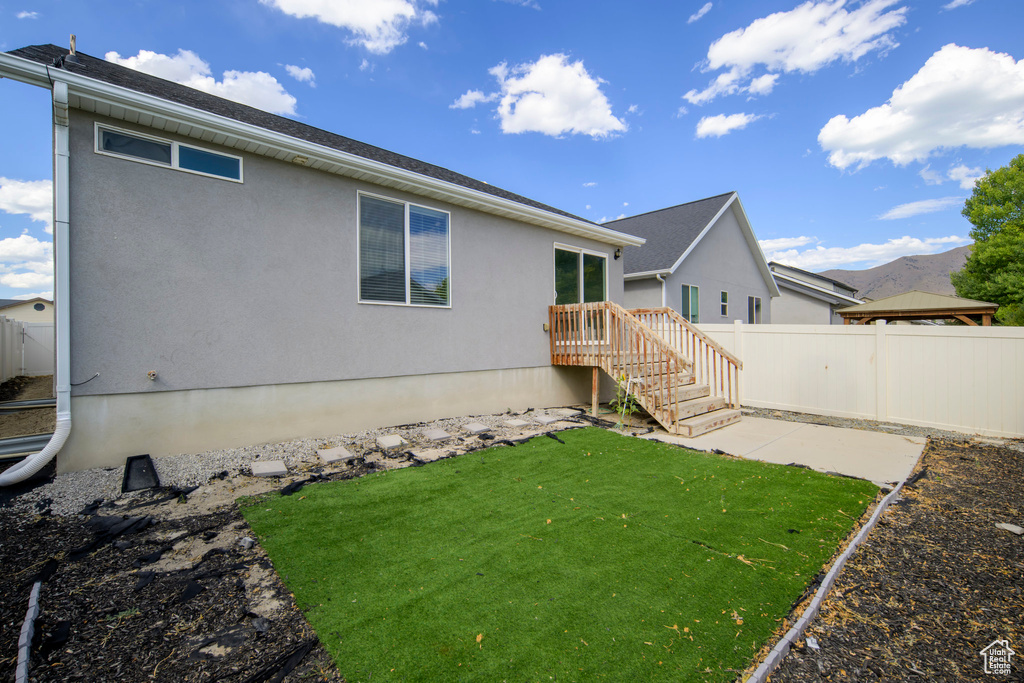 Back of house featuring a patio area and stucco siding