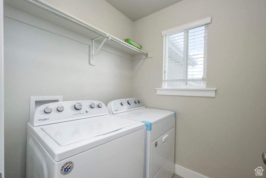 Laundry room with separate washer and dryer and baseboards
