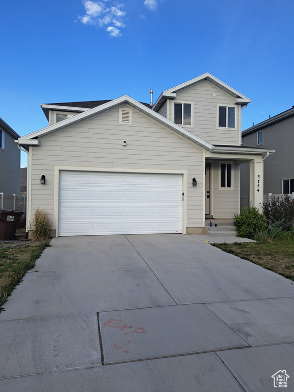 Traditional-style home with driveway and an attached garage