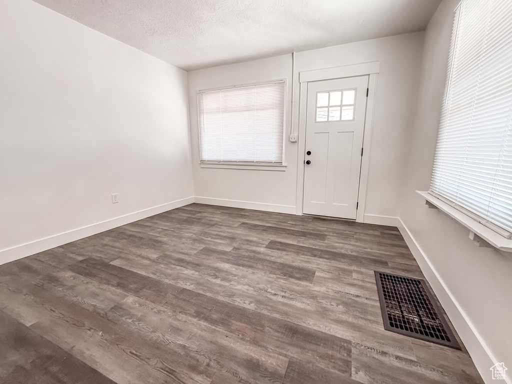 Foyer with wood finished floors and a textured ceiling