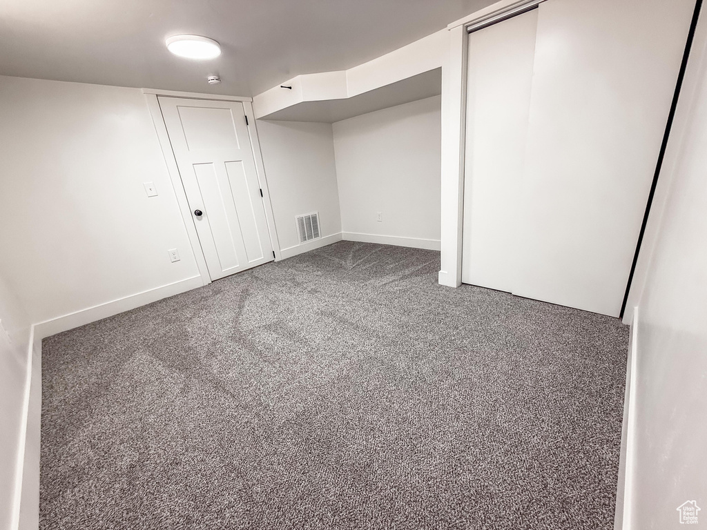 Finished basement with carpet floors and baseboards