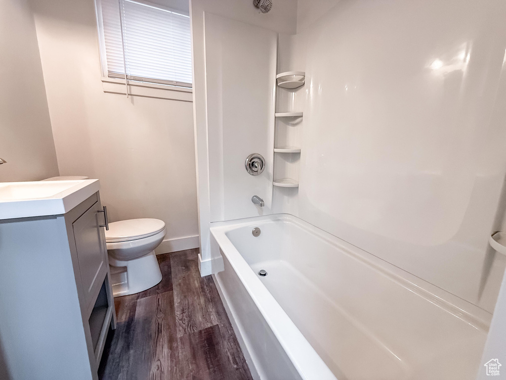Bathroom with wood finished floors, vanity, and shower / bathtub combination