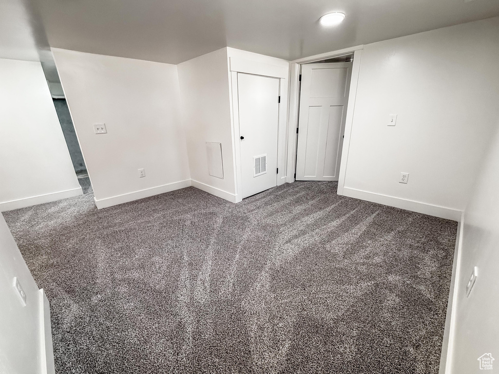 Unfurnished room featuring baseboards and carpet floors